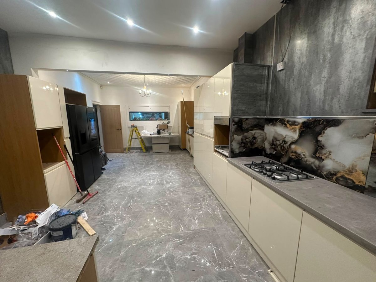 Kitchen renovation with cream cabinetry and marble flooring