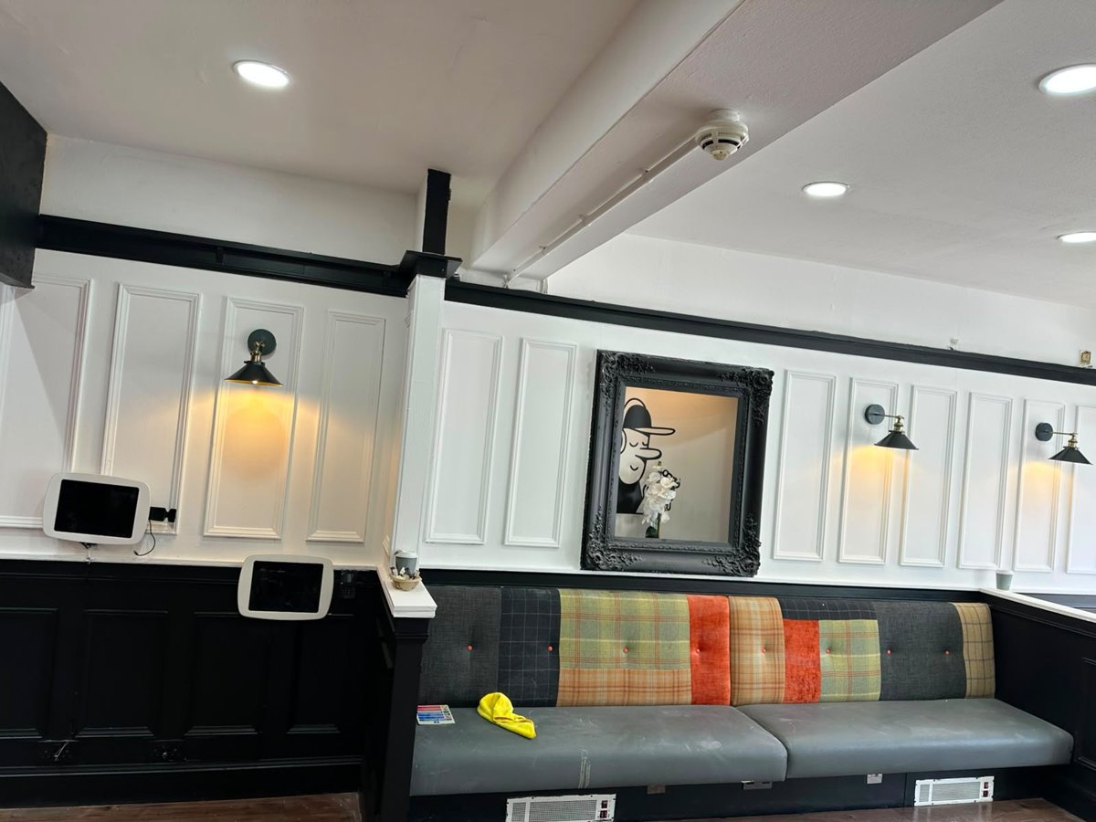 Painted wall panelling and seating booth
