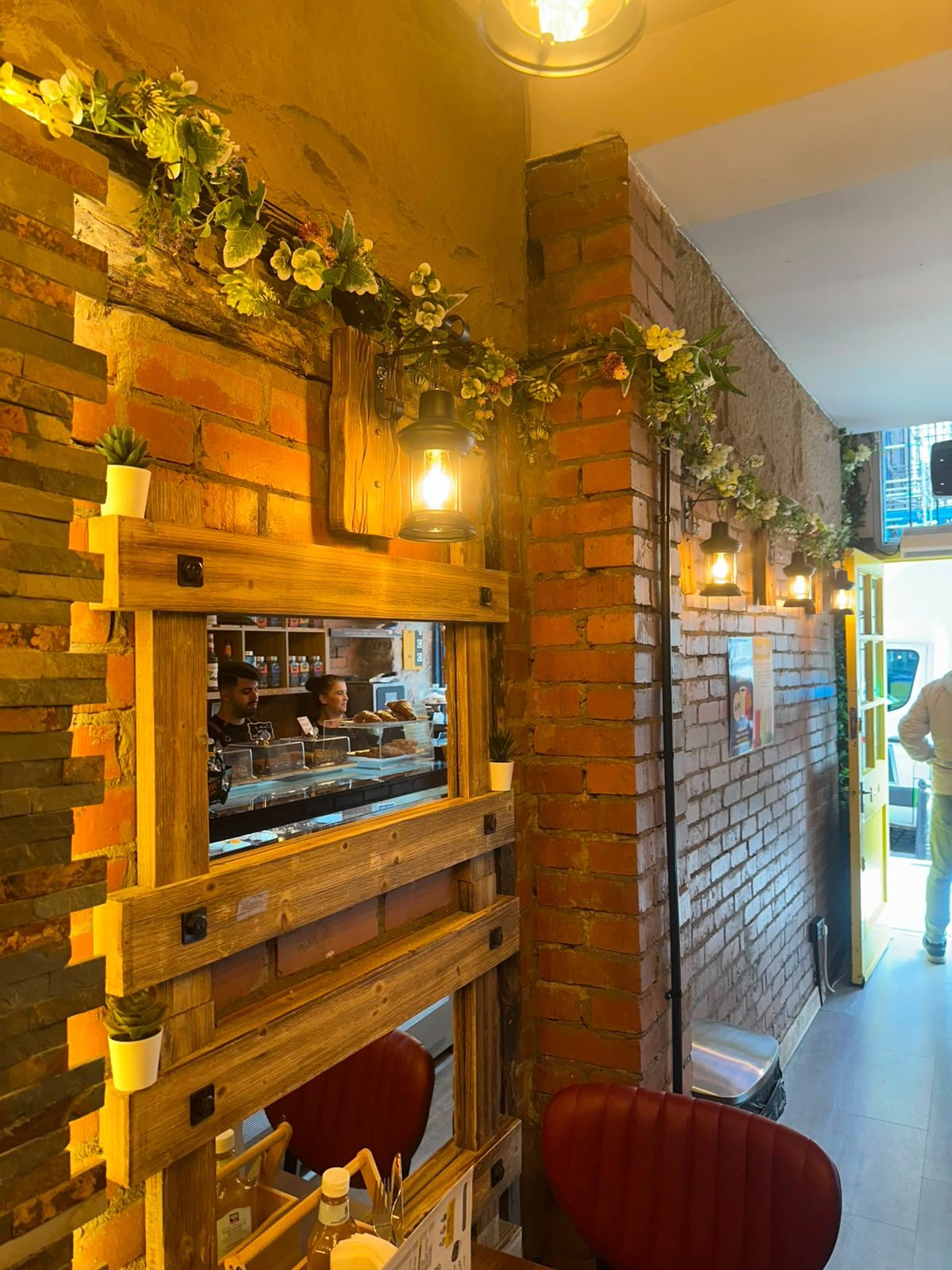 Cafe counter with exposed brick and feature lighting
