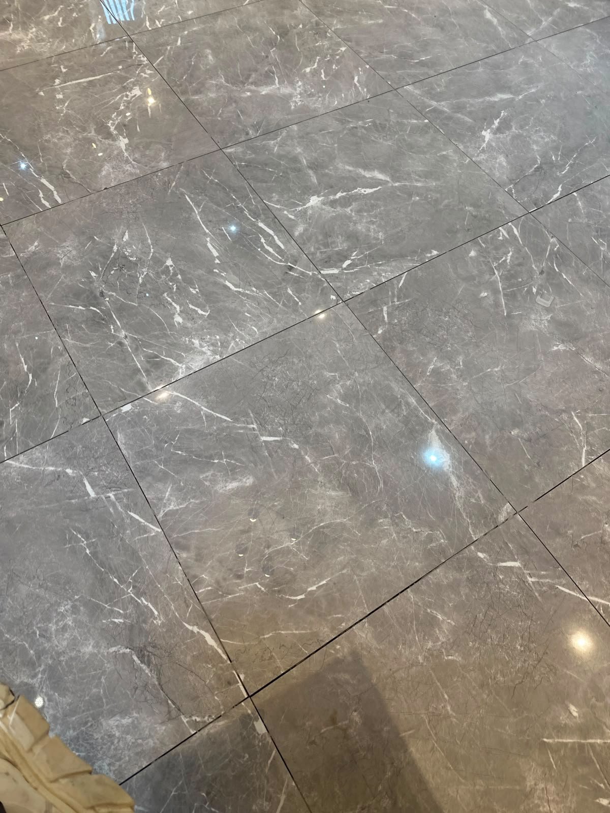 Polished marble-effect floor tiling