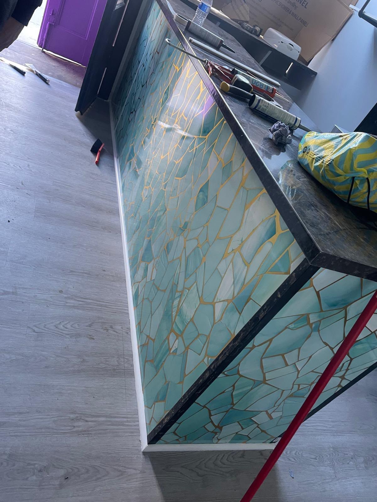 Mosaic tiled counter finish in teal and gold
